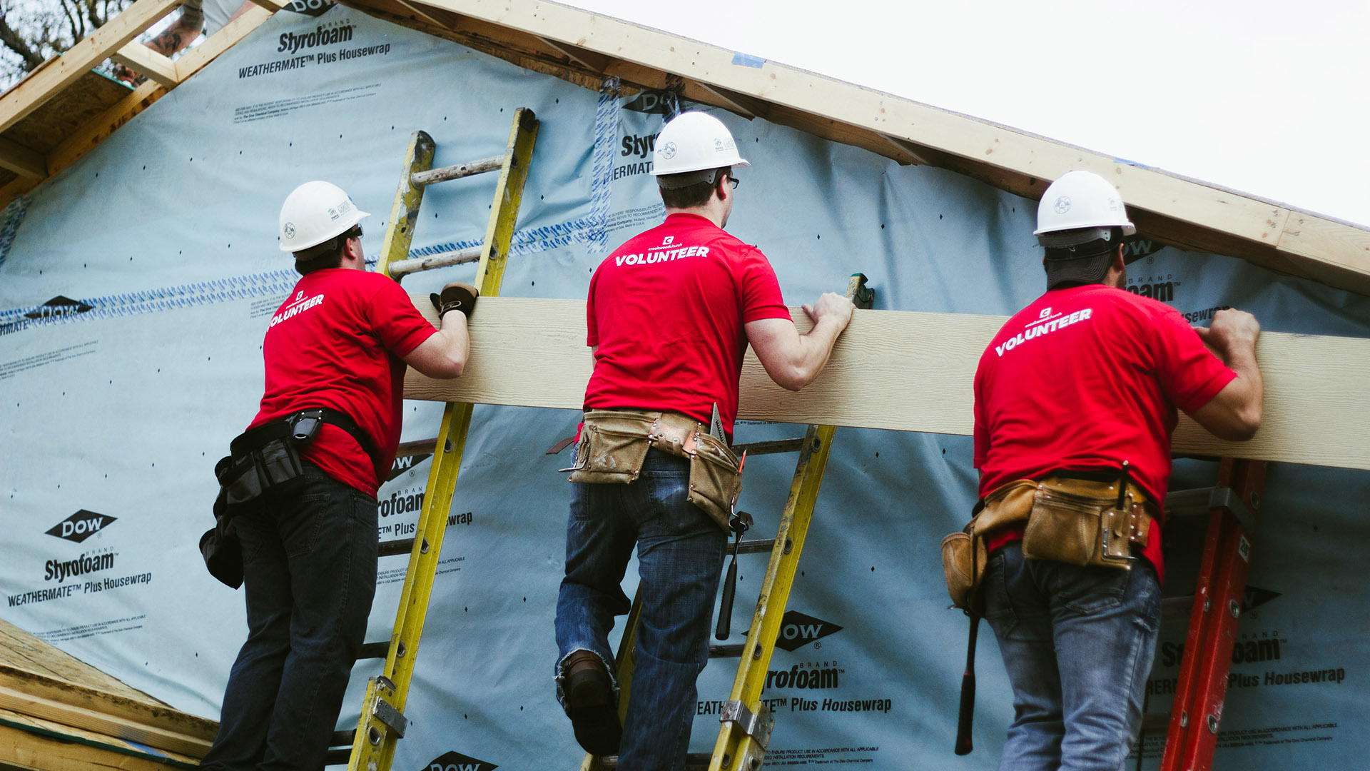 Creekwood volunteers doing hands-on repair work for a neighbor